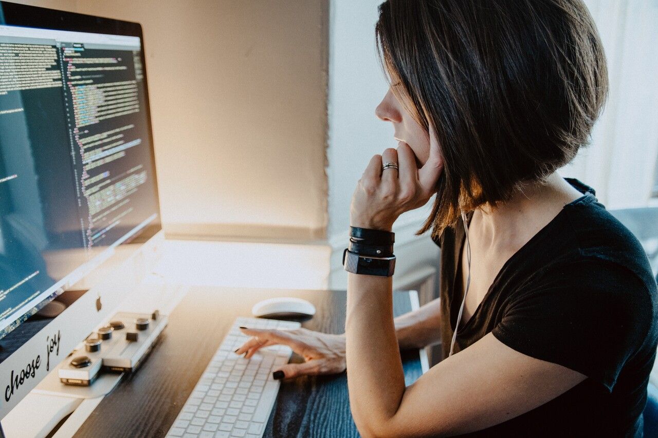 a developer woman sitting and examining the code